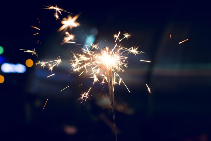 Hand holding 4th of July sparkler.