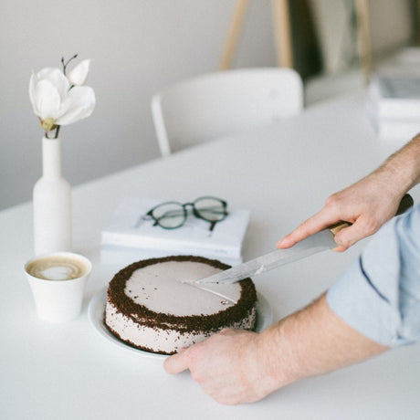 Man cutting into birthday cake.