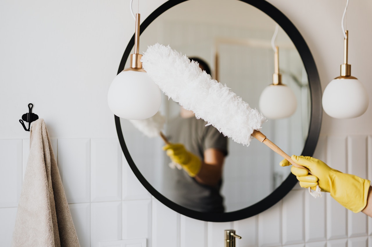 Woman cleaning home with products.