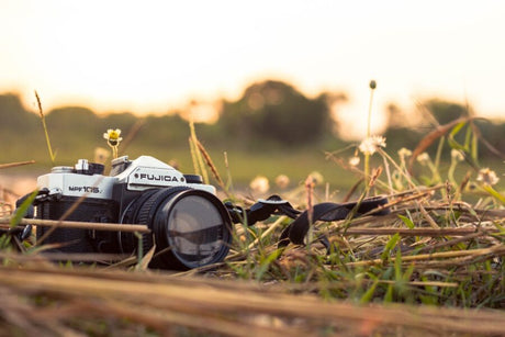 Camera sitting in field during the fall.