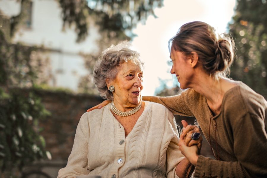 Mother and older daughter holding hands and laughing.