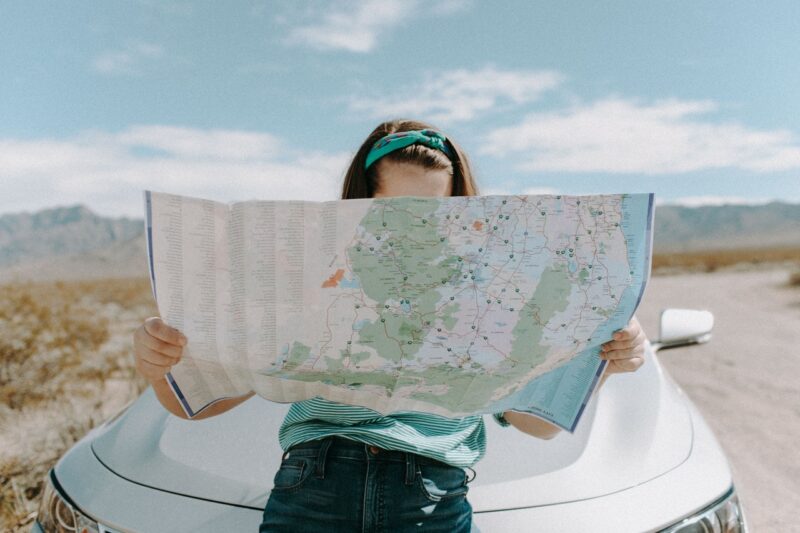 Woman looking over map to find a destination.