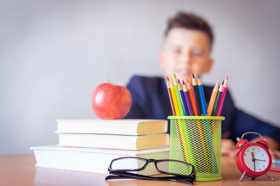 apple on books with eye glasses