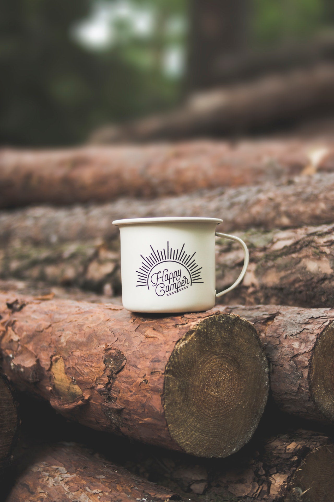 coffee cup on wooden log