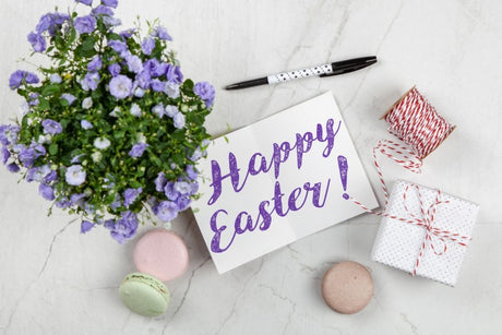 Happy Easter card next to purple flowers