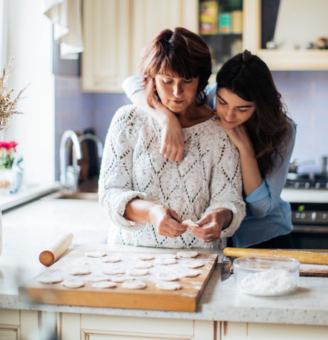 Woman and daughter baking cookies for Mother's Day